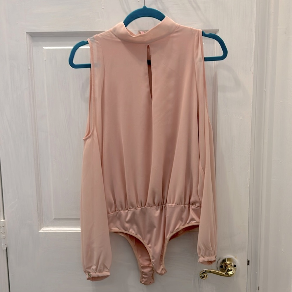Light pink cold shoulder body suit .